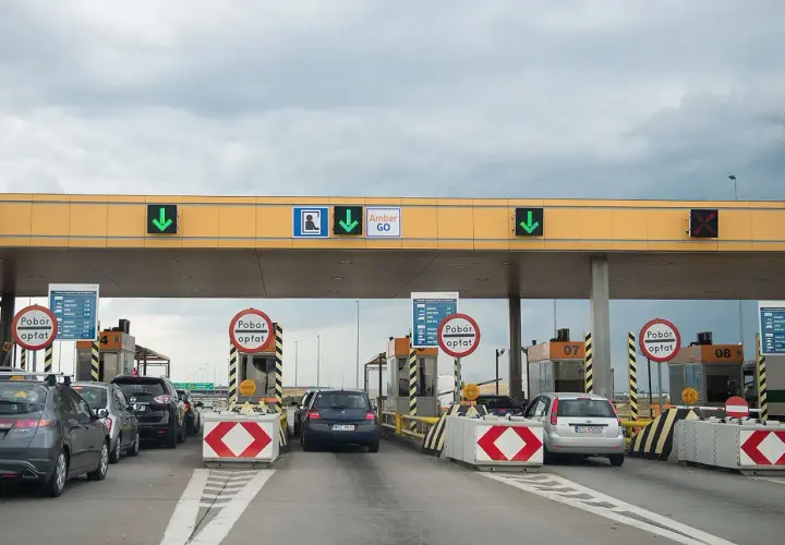 Korki na autostradzie przy bramkach poboru opłat. Samochody czekają w kolejce do przejazdu.