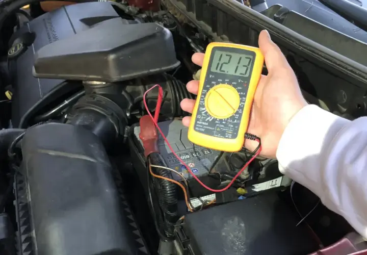 Pomiar napięcia multimetrem pokazuje 12.13V, co oznacza, że akumulator jest naładowany.